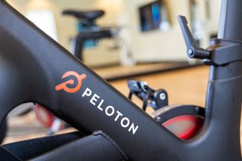 The logo on the seat of a stationary bike in a gym